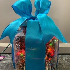 Glass canister with pinecones